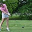 woman hitting golf ball off the tee