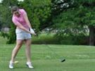 woman hitting golf ball off the tee